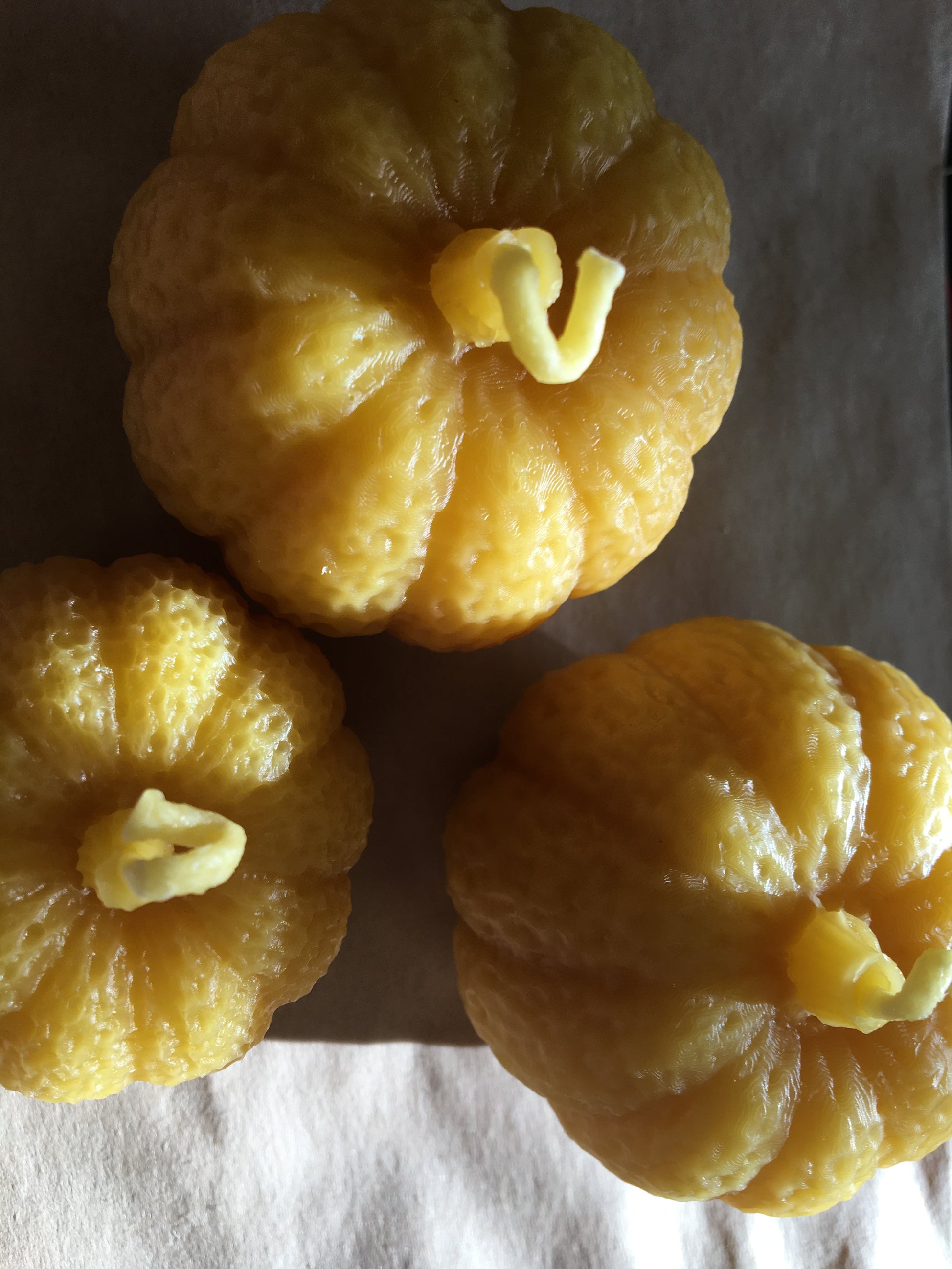 Beeswax pumpkin candles . Top view of small and medium candles